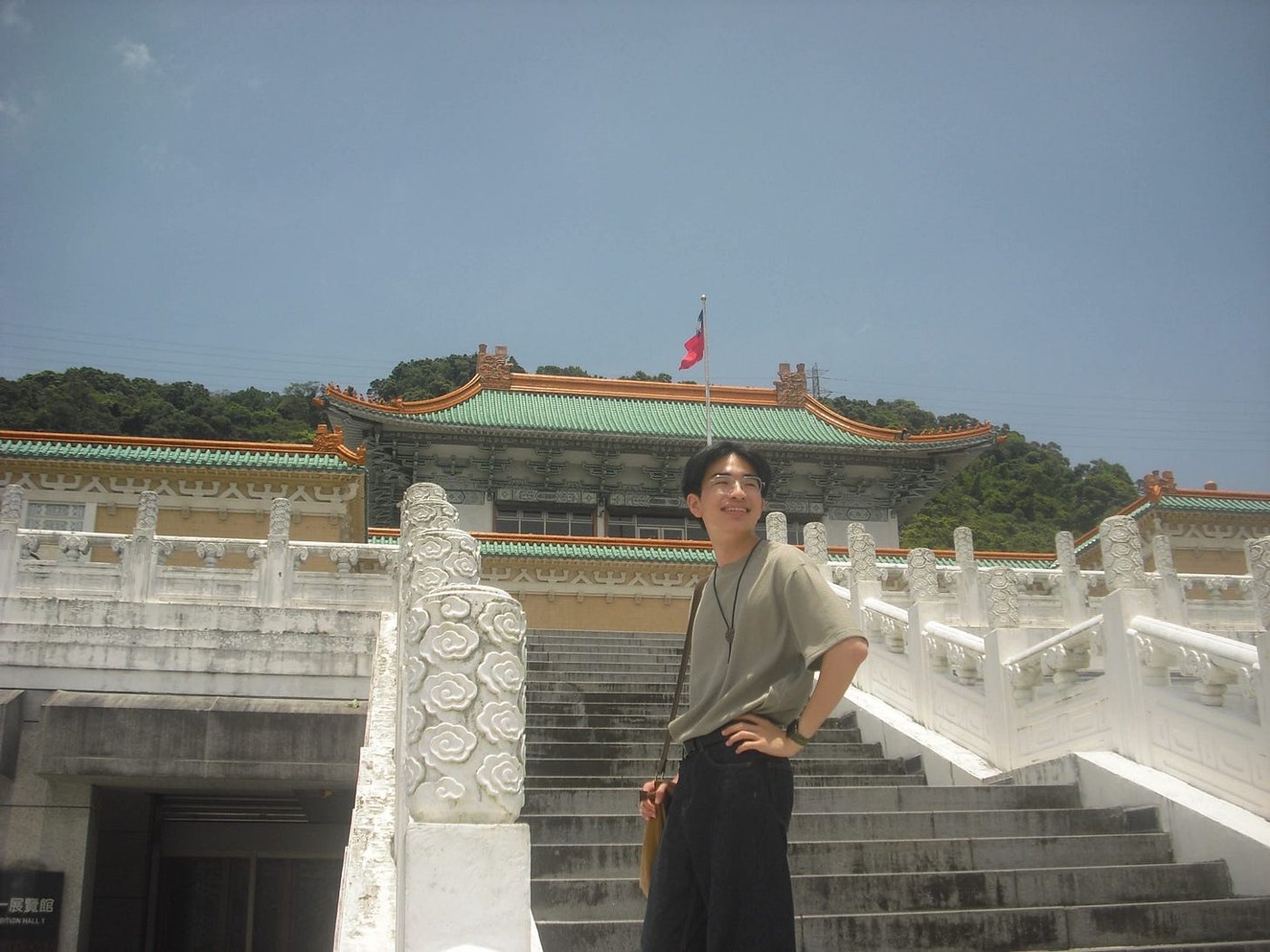 Published opening photograph from Developers of Lived Experience, showing a person on the steps in front of the National Palace Museum.