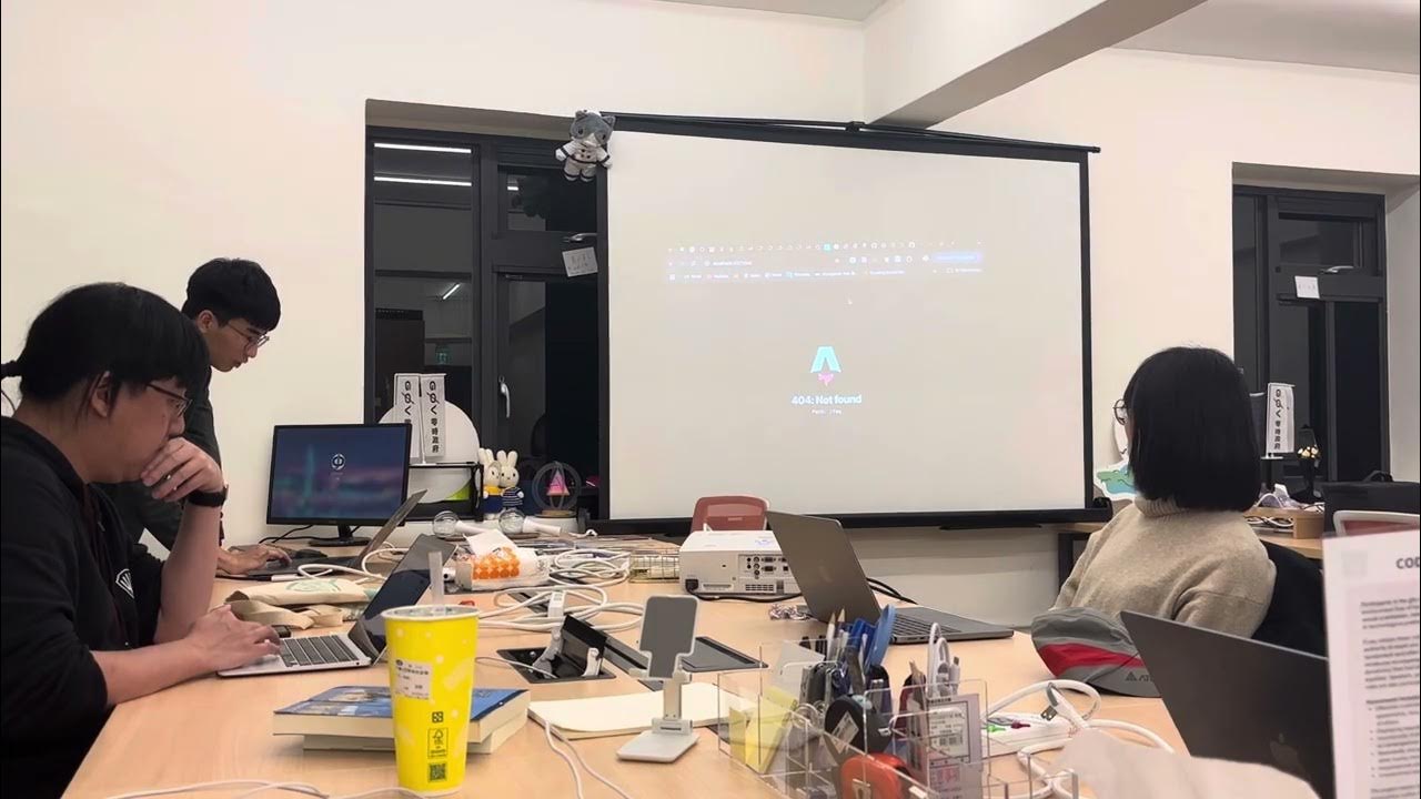 Thumbnail of a public vTaiwan gathering video, showing participants around a table with laptops, a projector and cables.
